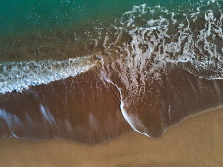 Aerial view of sandy beach and sea with waves, Top view, amazing nature background, beach and clear...