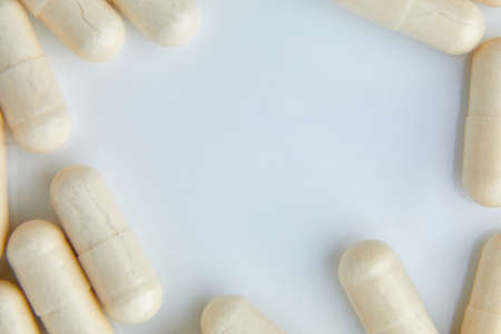 Flat lay macro White beige capsule pills, tablets, top viewの写真素材