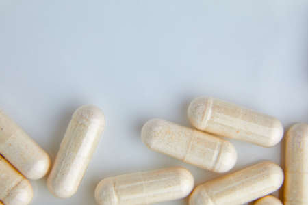 Flat lay macro White beige capsule pills, tablets, top viewの写真素材