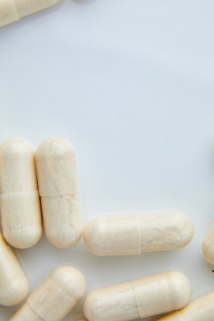 Flat lay macro White beige capsule pills, tablets, top view, close up texture background pharmaceutical industry concept, copy space.の写真素材