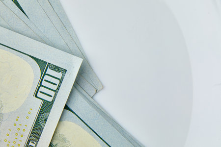 Flat lay Closeup on the bills for a US hundred dollar banknote, fragment of dollar bill, money background, copy space.の写真素材