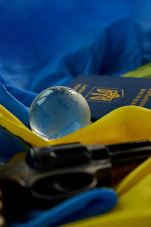 Flag of Ukraine, handgun, passport glass globe copy space, russia Ukraine war, Stop war, Freedom,...