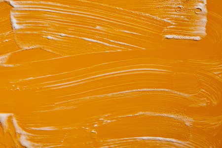 Texture of white soap foam with bubbles abstract yellow background, Soap, shower gel, shampoo, Face Cream cleansing mousse sample.の写真素材