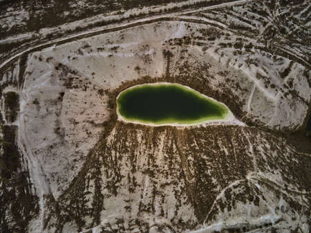 Aerial drone view a green lake formed on phosphogypsum waste, travel Ukraine, gypsum waste from factories, creating artificial white mountainsの写真素材