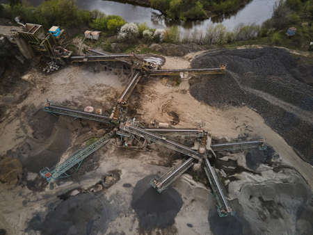 Aerial view basalt quarry of open pit mine machines with sifters and conveyor belts, Industry of...