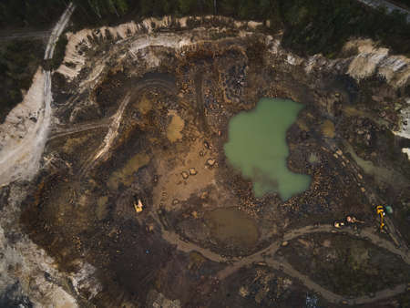 Aerial view basalt quarry of open pit with Bulldozer And Car, Industry of black basalt stone, stone quarryの写真素材