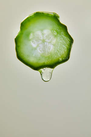 Gel, juice drips from cucumber slices with gel on white background, natural medicinal plant for organic cosmetics, alternative medicine, health and beauty spa concept, drop of cucumber.の写真素材