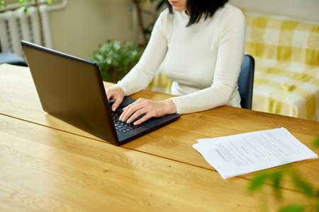 Close up female hands searching on laptop, woman working online, checking email, social network,...