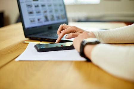 Unrecognizable woman using smartwatch, Freelancer female with smart watch on female wrist, using...