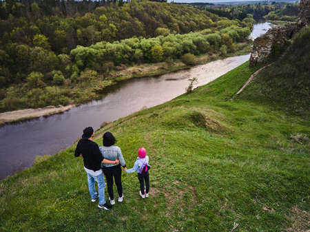 Mother, father daughter enjoys the view on the coast Sluch river hills, Gubkiv village Travel destinations in Ukraineの写真素材