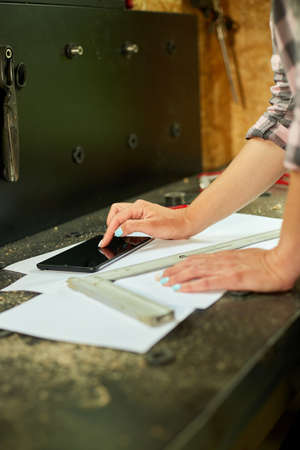 Female business owner using digital tablet in workshop, industrial woman engineer working with...