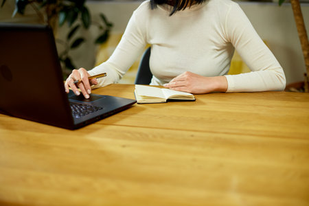 Woman hand making notes in notepad, businesswoman freelancer