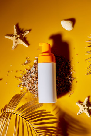 Top view, flat lay Sunscreen tube mockup with shells, sand yellow background, summer vacations and spf uv-protecting skin care concept, hard light.の写真素材