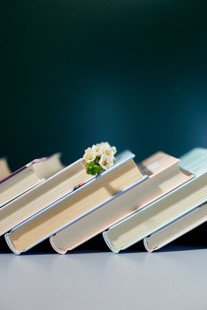 Stack of books with branch flowers, World book day, knowledge and creativity concept, spring, summer mood, copy space.の写真素材