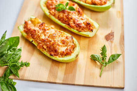 Stuffed zucchini on white background, baked loaded zucchini boats, Top view, Homemade.の写真素材