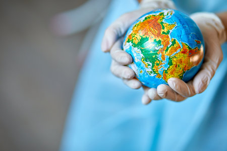 Healthcare worker symbolically cradling the Earth, showcasing care for global health.の写真素材