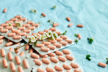 An artistic arrangement of medication with spring blossoms symbolizing health and renewal.