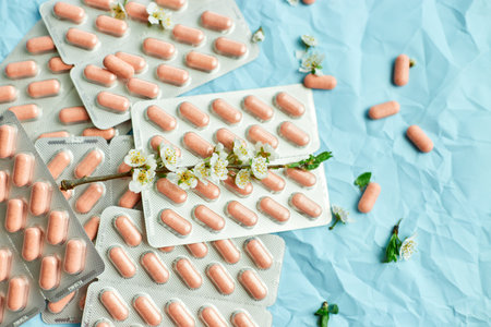 An artistic arrangement of medication with spring blossoms symbolizing health and renewal.