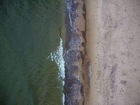 Waves crashing on Beach. Baltic sea in autumn from drone.Nature from a birds eye view. From air.の写真素材