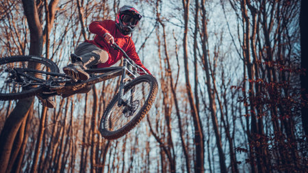 Riding on mtb bikes, downhill bikes in autumn forest on bike trails wish tricks and huge gaps and jumpsのeditorial素材