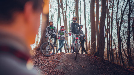 Riding on mtb bikes, downhill bikes in autumn forest on bike trails wish tricks and huge gaps and jumpsのeditorial素材