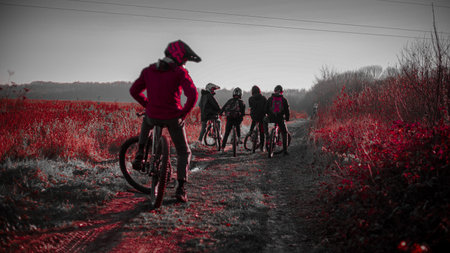 Riding on mtb bikes, downhill bikes in autumn forest on bike trails wish tricks and huge gaps and jumpsのeditorial素材