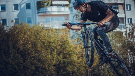 Summer riding on mtb bikes on pumptrack 4cross with tricks and big air jumps in outdoor bike parkのeditorial素材