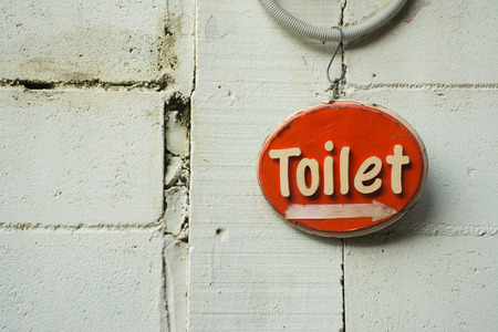 Retro red toilet sign on white brick wallの写真素材