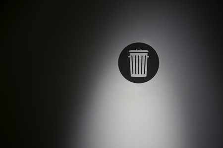 Bin symbol in highlight concrete wall.の写真素材