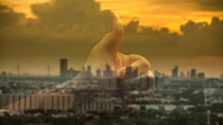 Abstract blur of industrial city before sunset with thumb upの写真素材