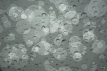 Abstract blur of Water Drops on glass with bokeh, use for Backgroundの写真素材