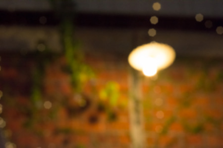 Abstract blurred of lamp and beautiful bokeh with brick wall.