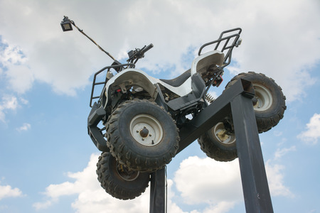 ATV Quad Bike on stand with blue sky backgroundの写真素材