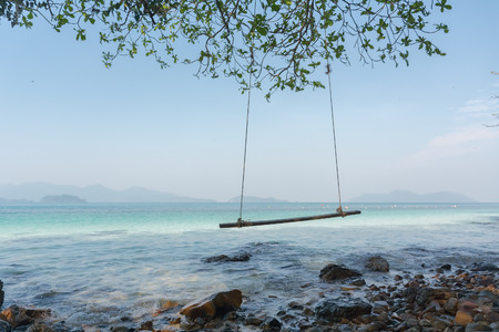 Swings at tree on the sand and rock beautiful tropical beach at koh wai island, Trat, Thailand.の写真素材
