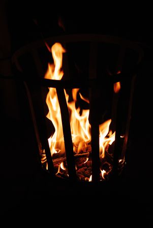 Fire and smoke in a metal basketの写真素材