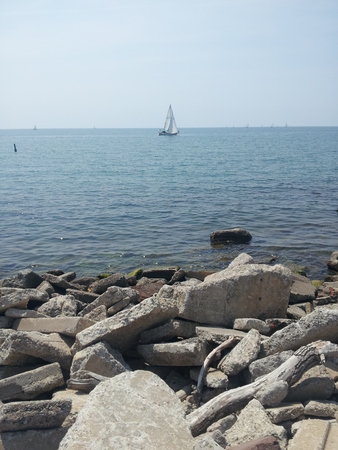 Waterfront View of Sail Boatの写真素材