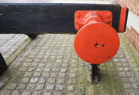 Bright red railway buffer set in cobblesの写真素材