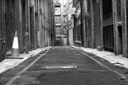 Looking down a long dark back alleyの写真素材