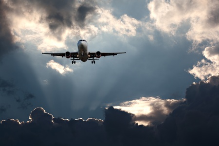 Passenger plane on final approach, against a stormy skyの写真素材