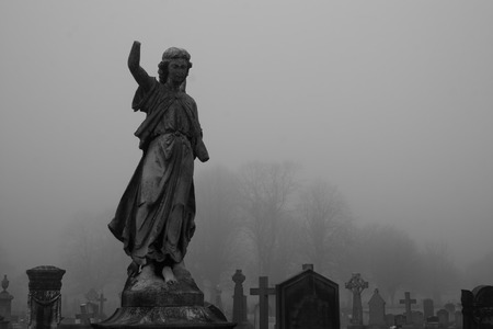 Graveyard statue on a foggy winters day
