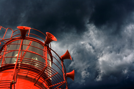 Red lightship with fog horns against storm cloudsの写真素材