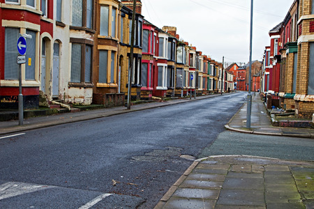 A street of boarded up derelict houses awaiting regemeration in Liverpool UKのeditorial素材