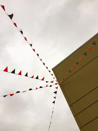 Triangular shaped bunting flags attached to building.の写真素材