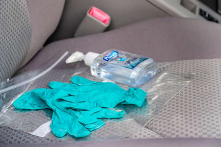 Surrey, Canada - Mar. 25, 2020: Medical gloves and hand sanitizer on car seatのeditorial素材