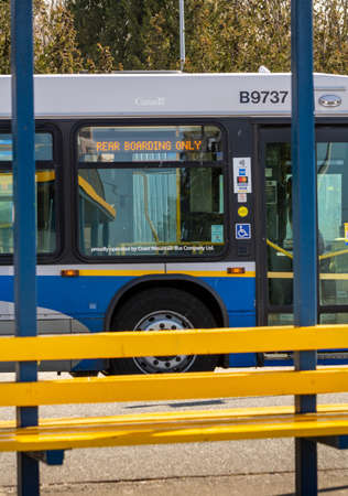 N. Vancouver, Canada - Apr 7, 2020: Public transit bus displaying message to enter rear doors during Covid-19 pandemicのeditorial素材