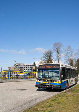 N. Vancouver, Canada - Apr 7, 2020: Public transit bus displaying message to enter rear doors during...