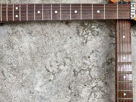 Two Rosewood guitar neck on old grey concrete. Background and wallpaper.の写真素材