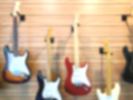 Blurred music store interior space with electric guitar background.の写真素材