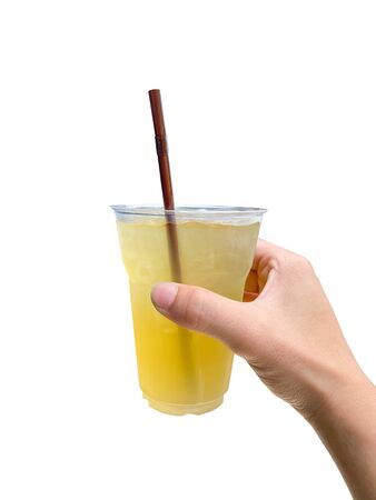 The hand of a person holding a glass of cold green tea on white background with work path.の写真素材