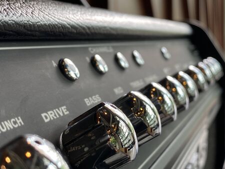 Close-up Silver knob, black plate modern combo multieffect amplifier.の写真素材